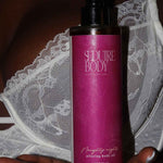 a photo of the seduire body naughty nights natural fragrance free body oil for dry and sensitive eczema prone skin being held in a womans hand