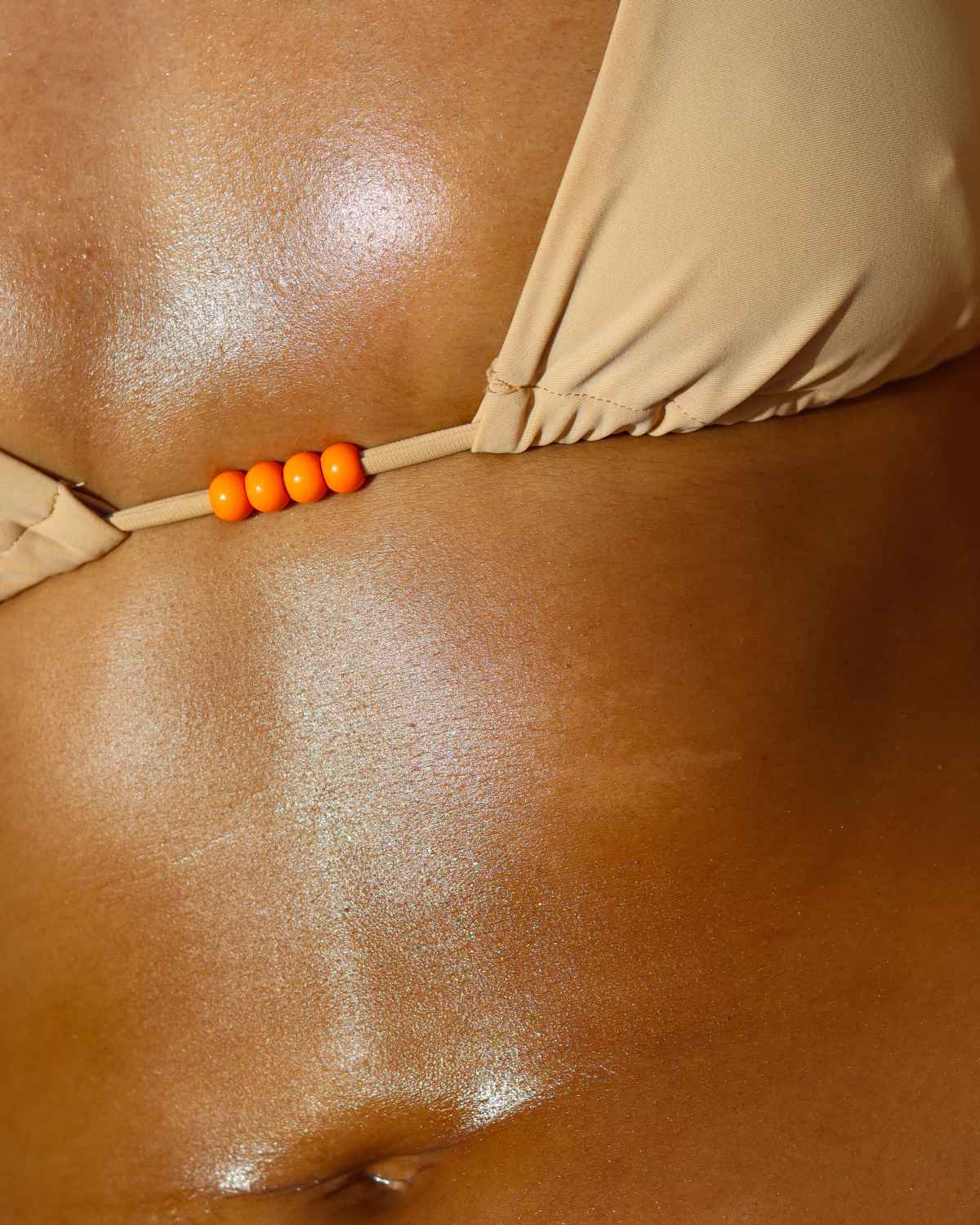 a photo of a woman's torso showing the glowing moisturized results of using this fragrance free natural body oil on the body during her body care routine