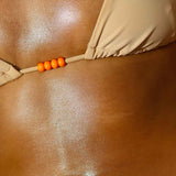 a photo of a woman's torso showing the glowing moisturized results of using this fragrance free natural body oil on the body during her body care routine