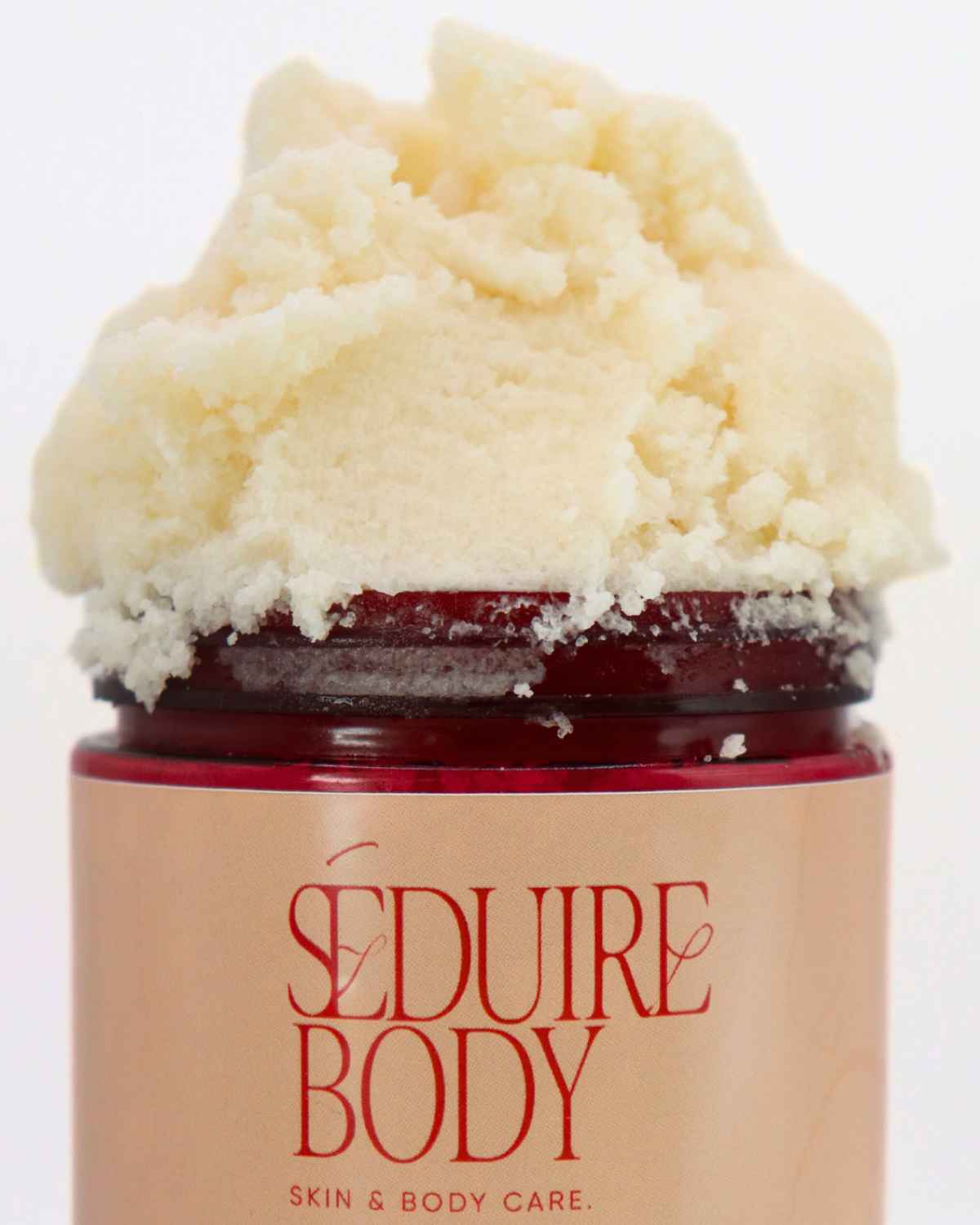 a close up shot of the strip tease body scrub for body acne, hyperpigmentation, strawberry legs and clogged pores