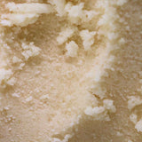 a close up texture shot of our vanilla scented body scrub for body acne, hyperpigmentation, dull skin, strawberry legs and clogged pores