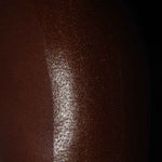 a photo showing the results of the attention seeker shimmer oil on black skin. the best shimmer oil for bronzing, glitter, shine and glow